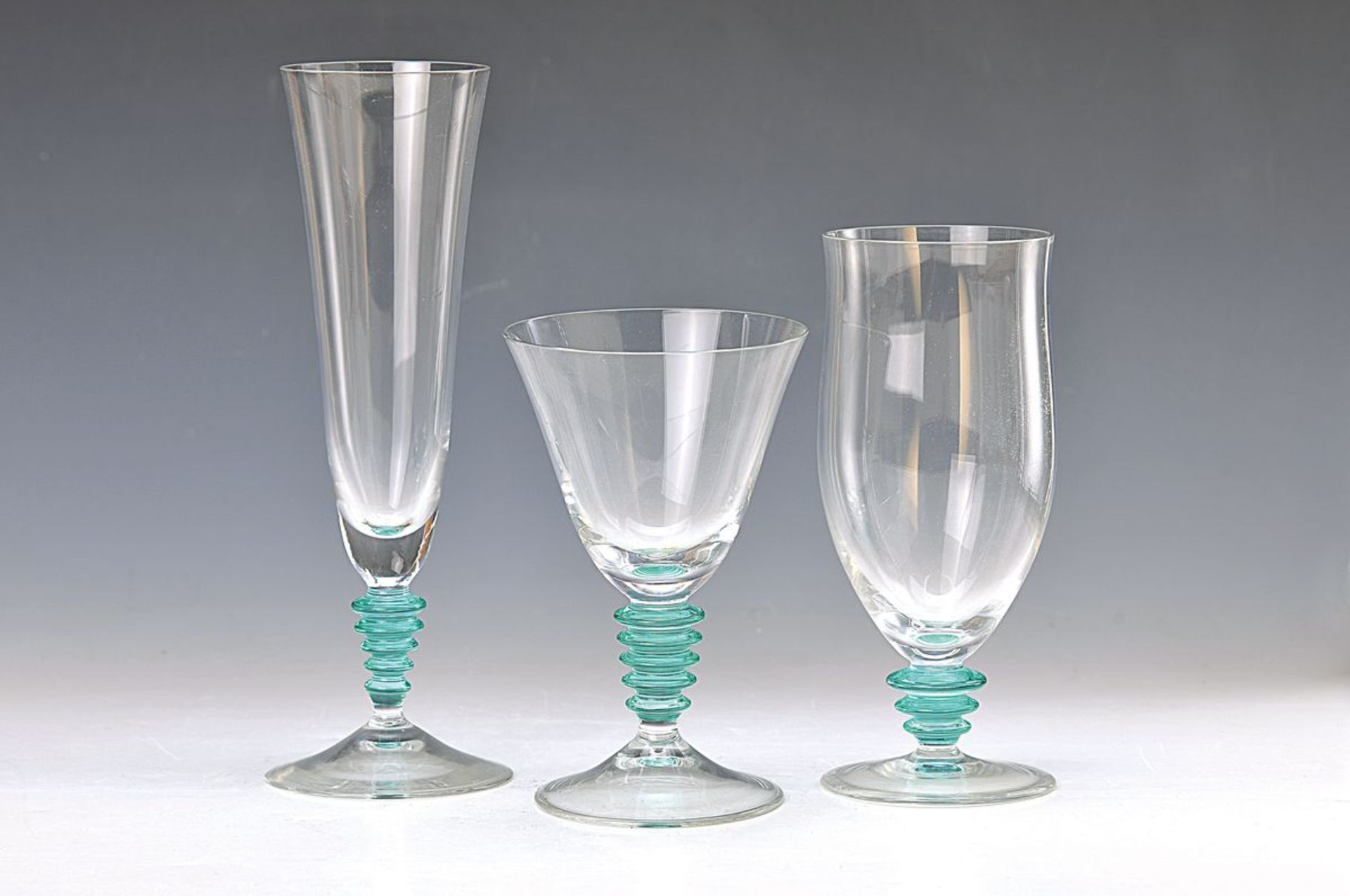 28 glasses, Italy, 1970s, colorless glass with green stepped stems, 10 champagne glasses 22cm, 12