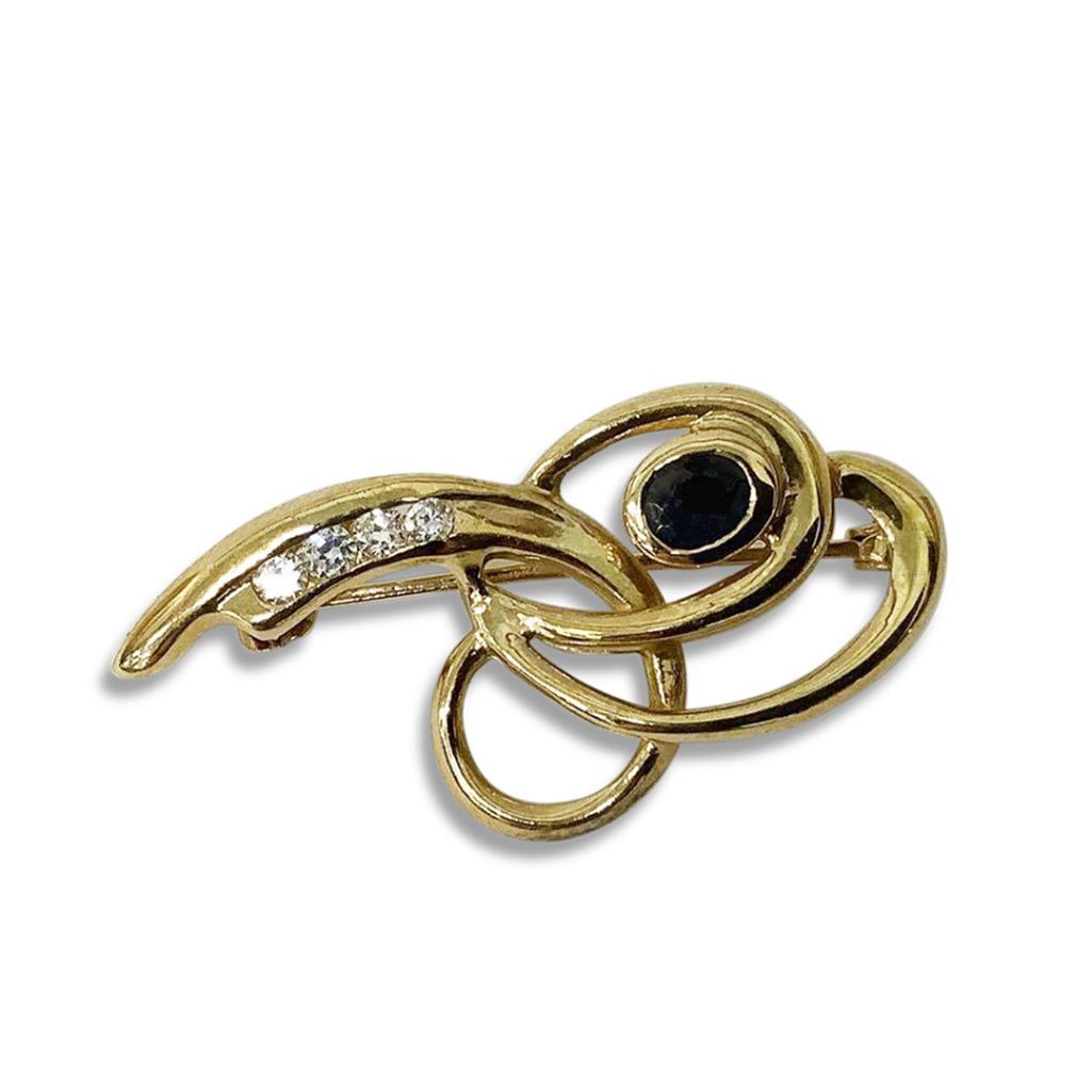 YELLOW METAL AND GEM SET BROOCH