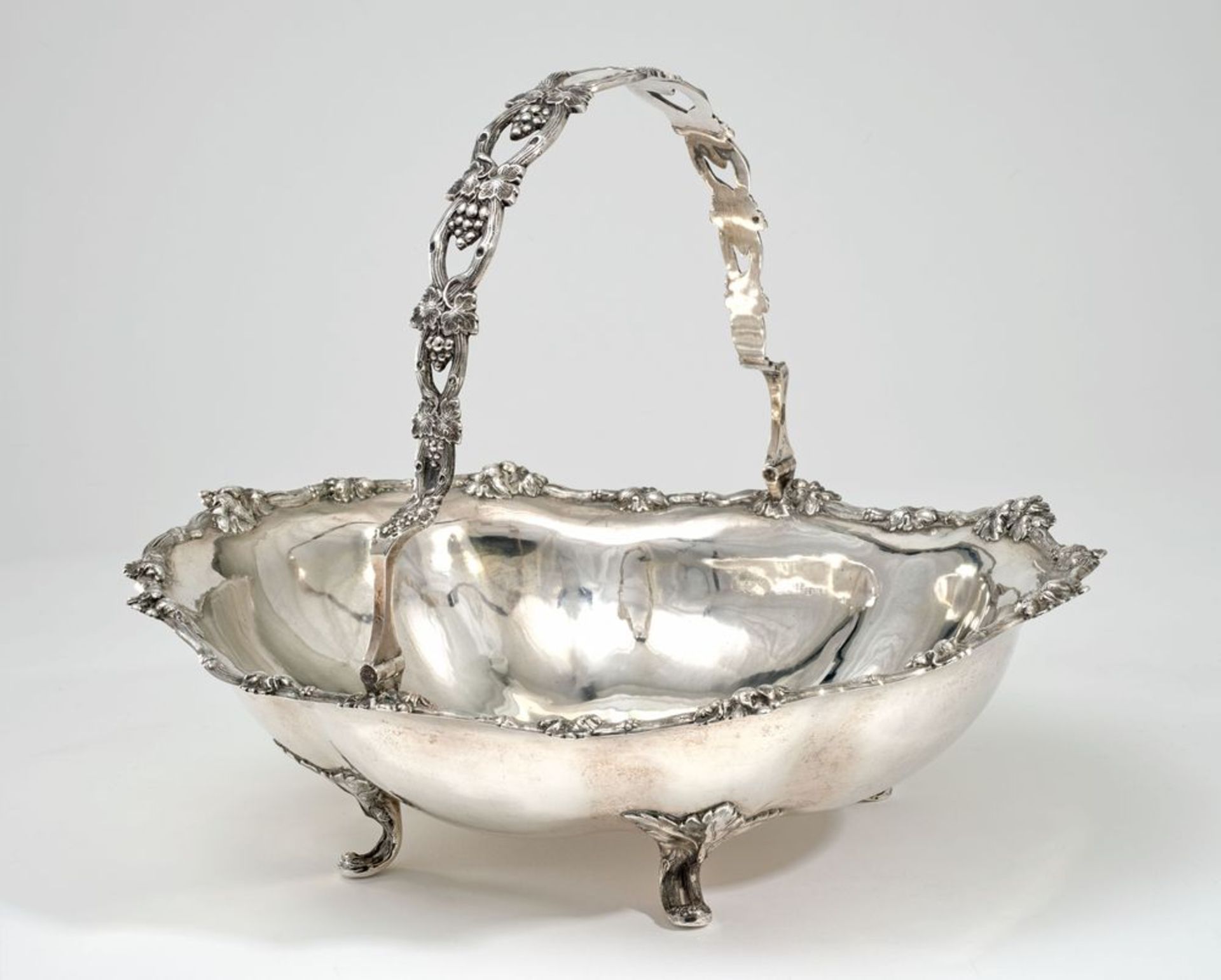 Silver-gilt fruit basket with handle and border decorated with vine scrolls and [...]