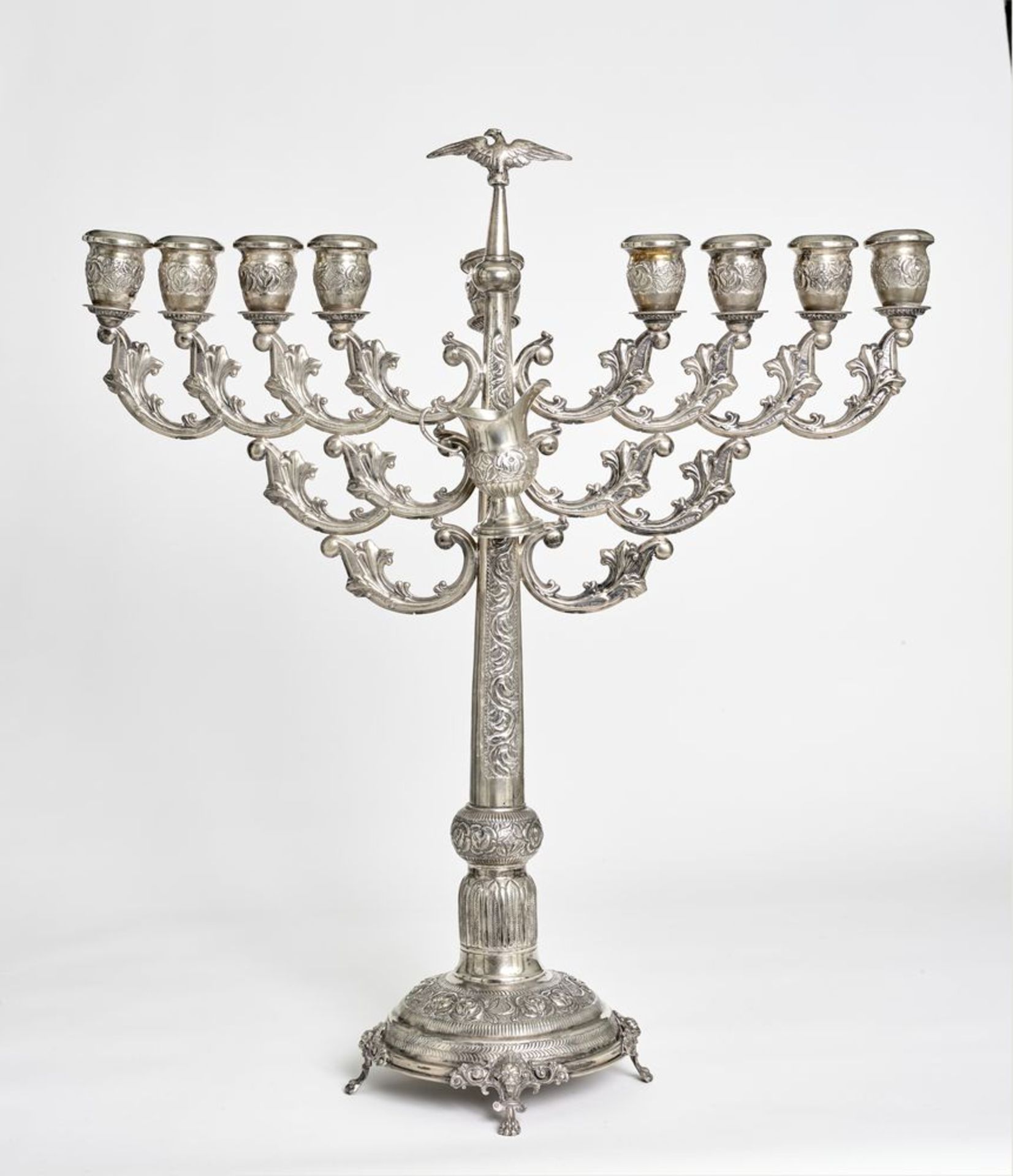 A Russian sterling silver Hanukkah lamp with detachable oil jug decorated with floral [...]