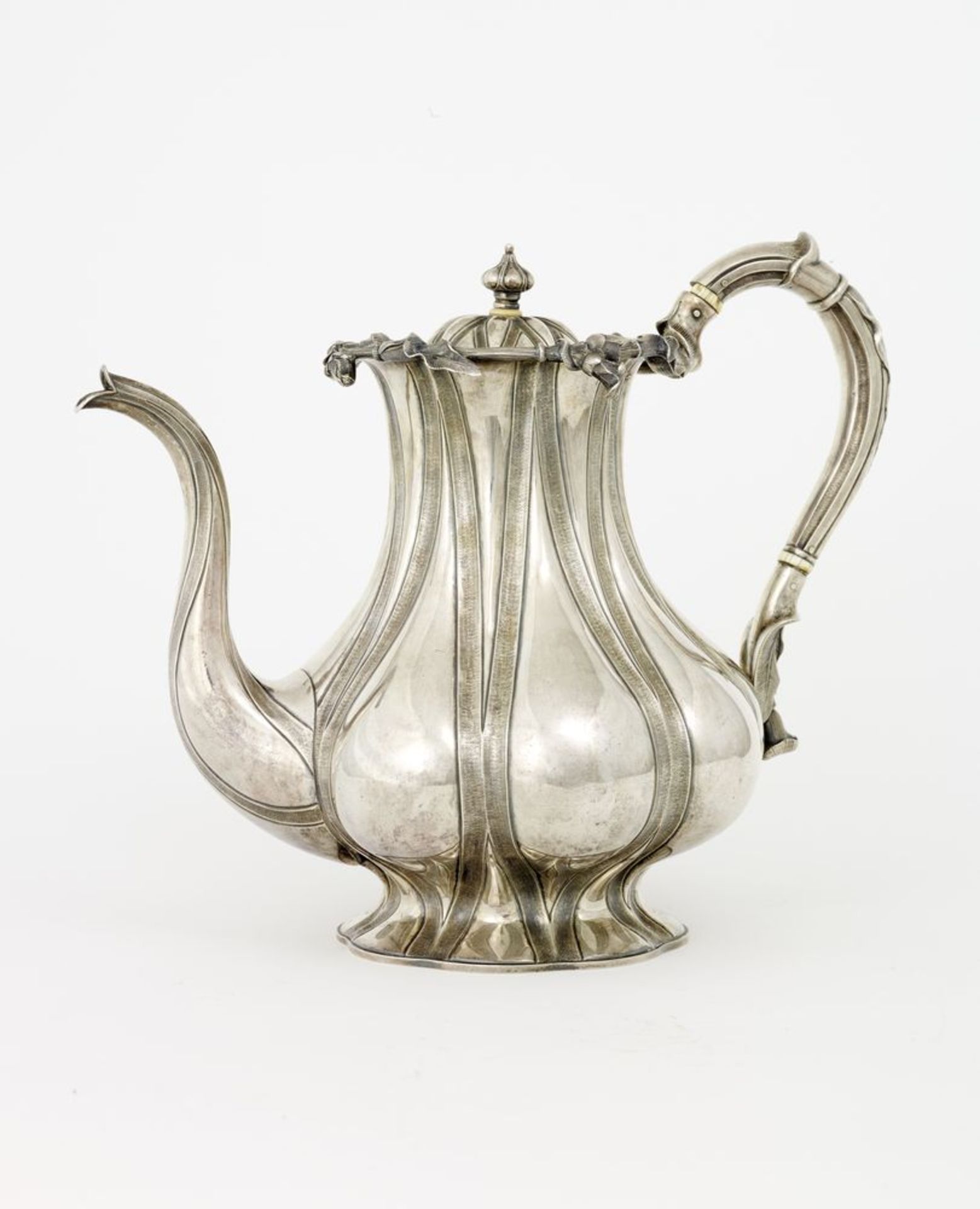 Silver-gilt lobed teapot and sugar bowl adorned with embossed floral decor Assay [...]