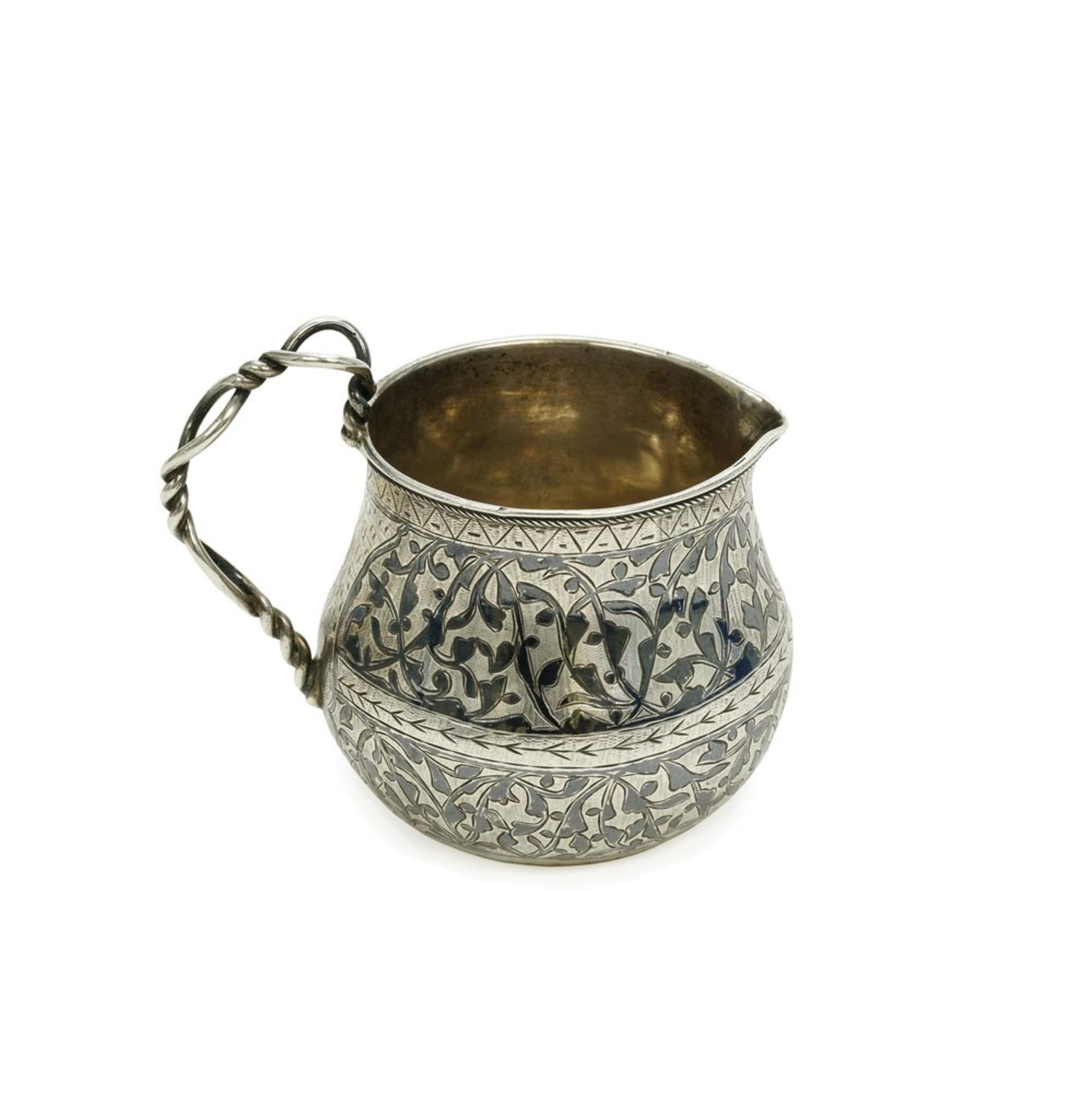 Silver creamer decorated with floral ornaments with a curled handle. Master K. G. [...]