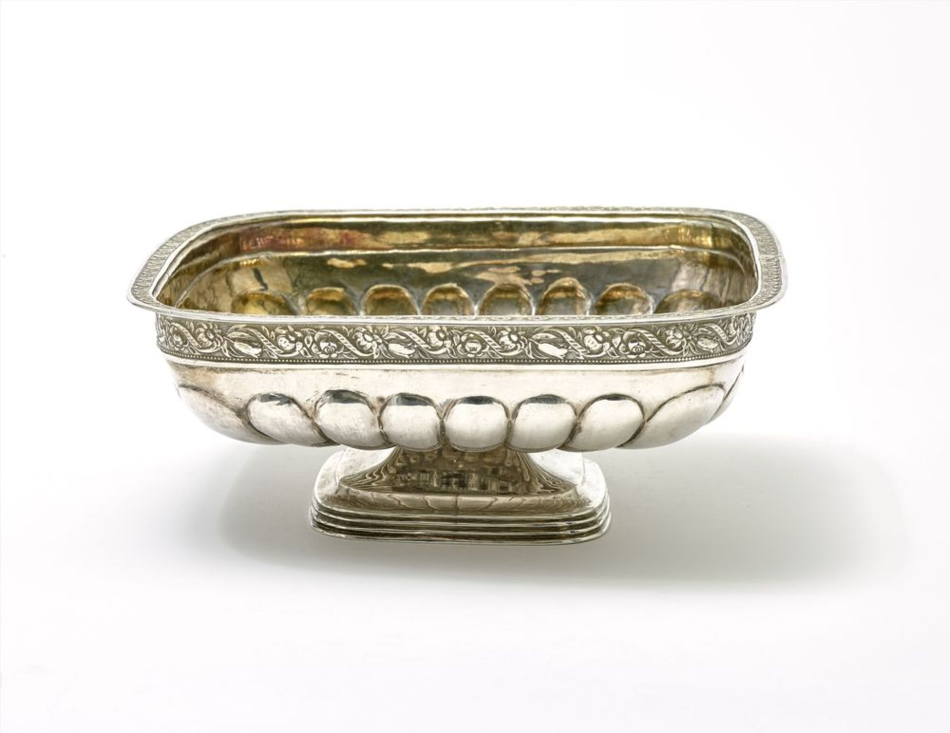 Silver-gilt candy bowl, square-shaped and decorated with floral ornament. [...]