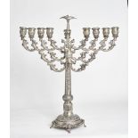 A RUSSIAN STERLING SILVER HANUKKAH LAMP WITH DETACHABLE OIL JUG DECORATED WITH [...]