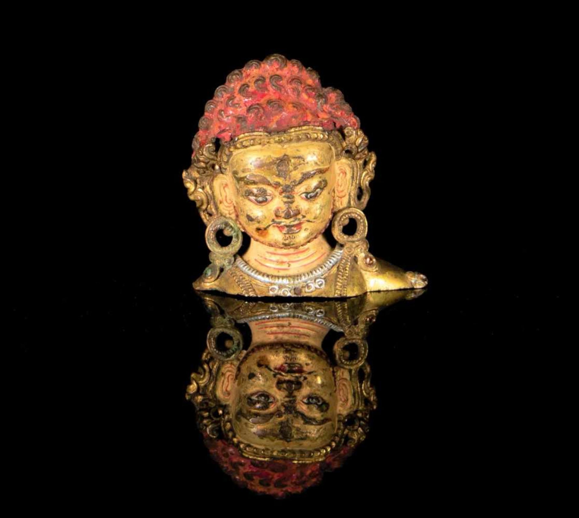 A gilt bronze head of Mahakala.