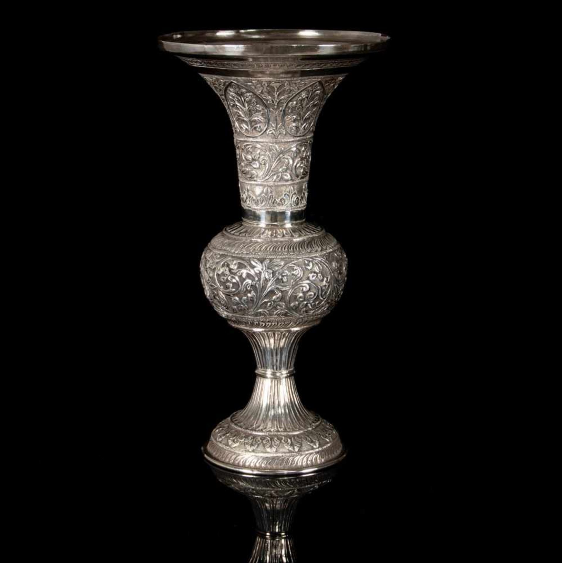 A silver repoussé vase