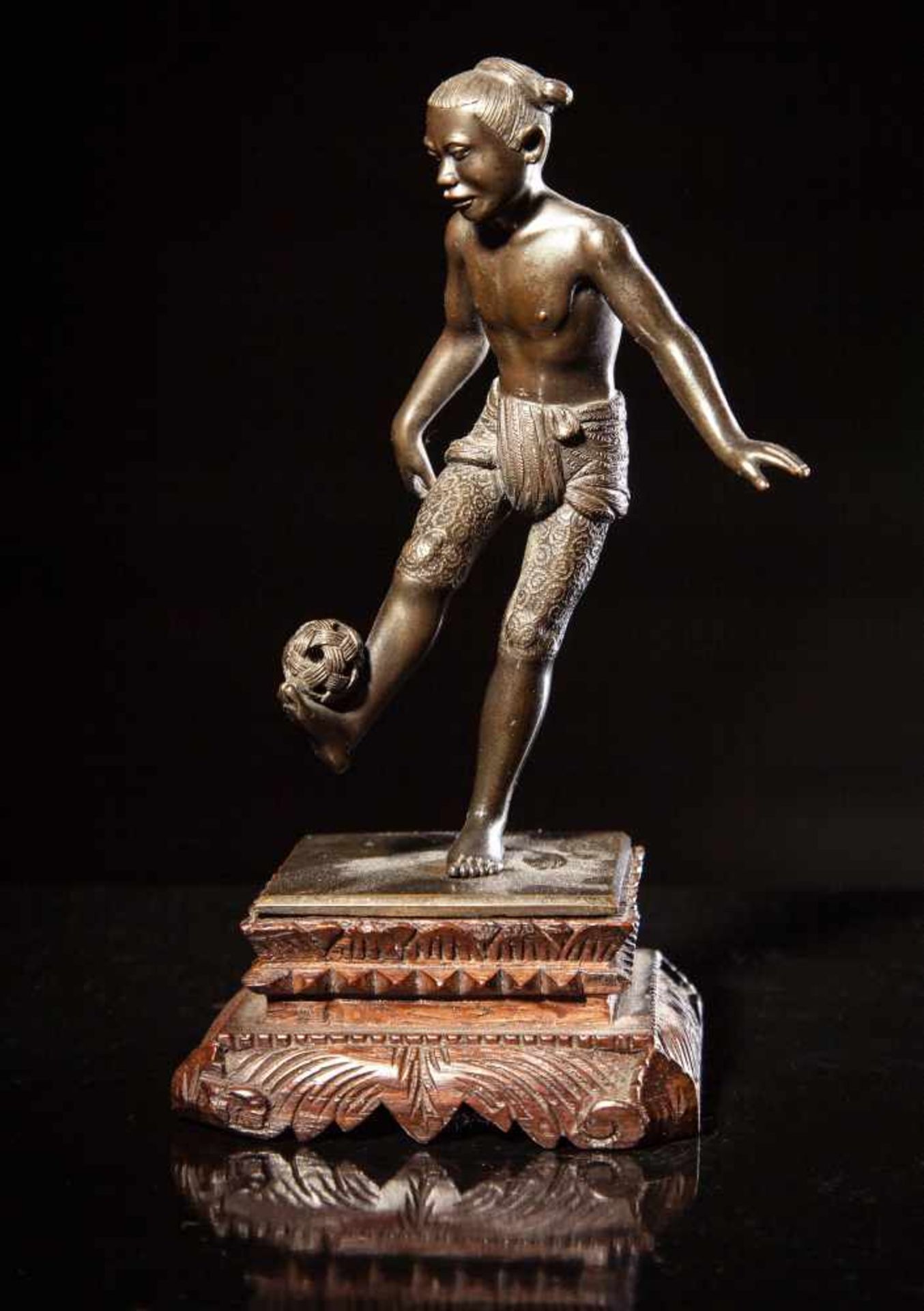 A Bronze Figure of a Young Boy