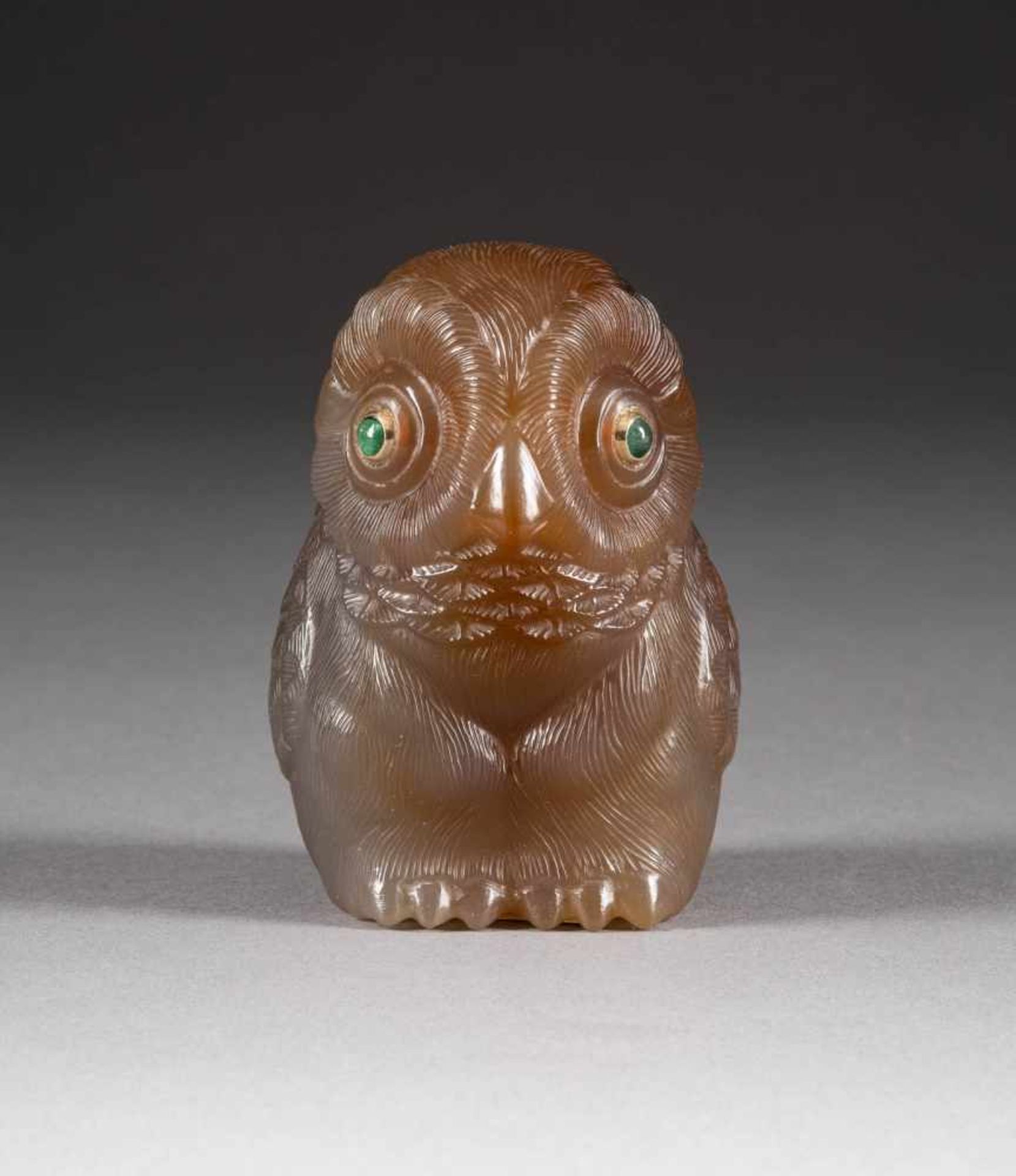 A HARDSTONE FIGURE OF AN OWL