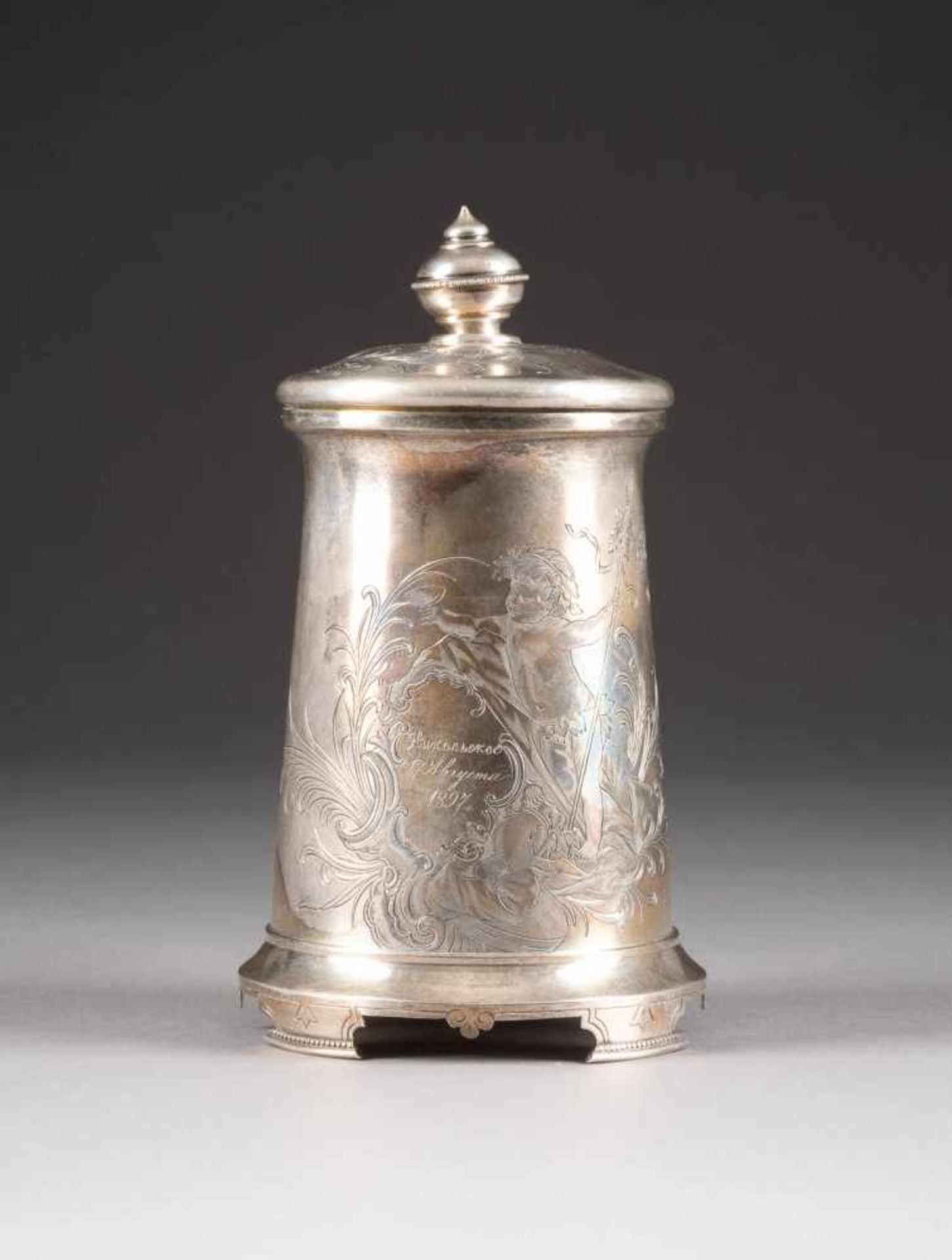 A SILVER TANKARD WITH BACCHUS