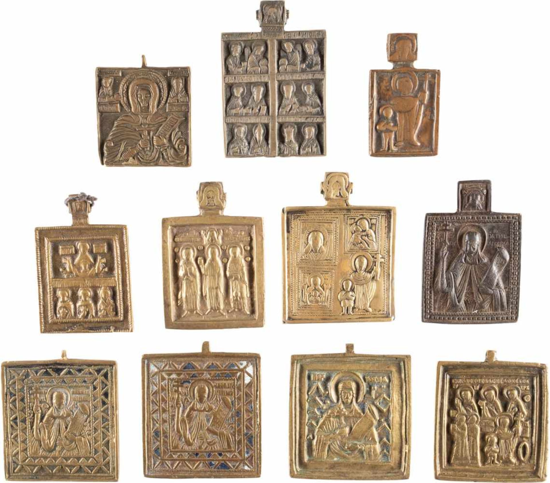 A COLLECTION OF ELEVEN BRASS ICONS SHOWING SELECTED SAINTS