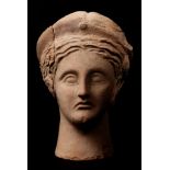 A Roman Terracotta Votive Head  Height 10 inches.