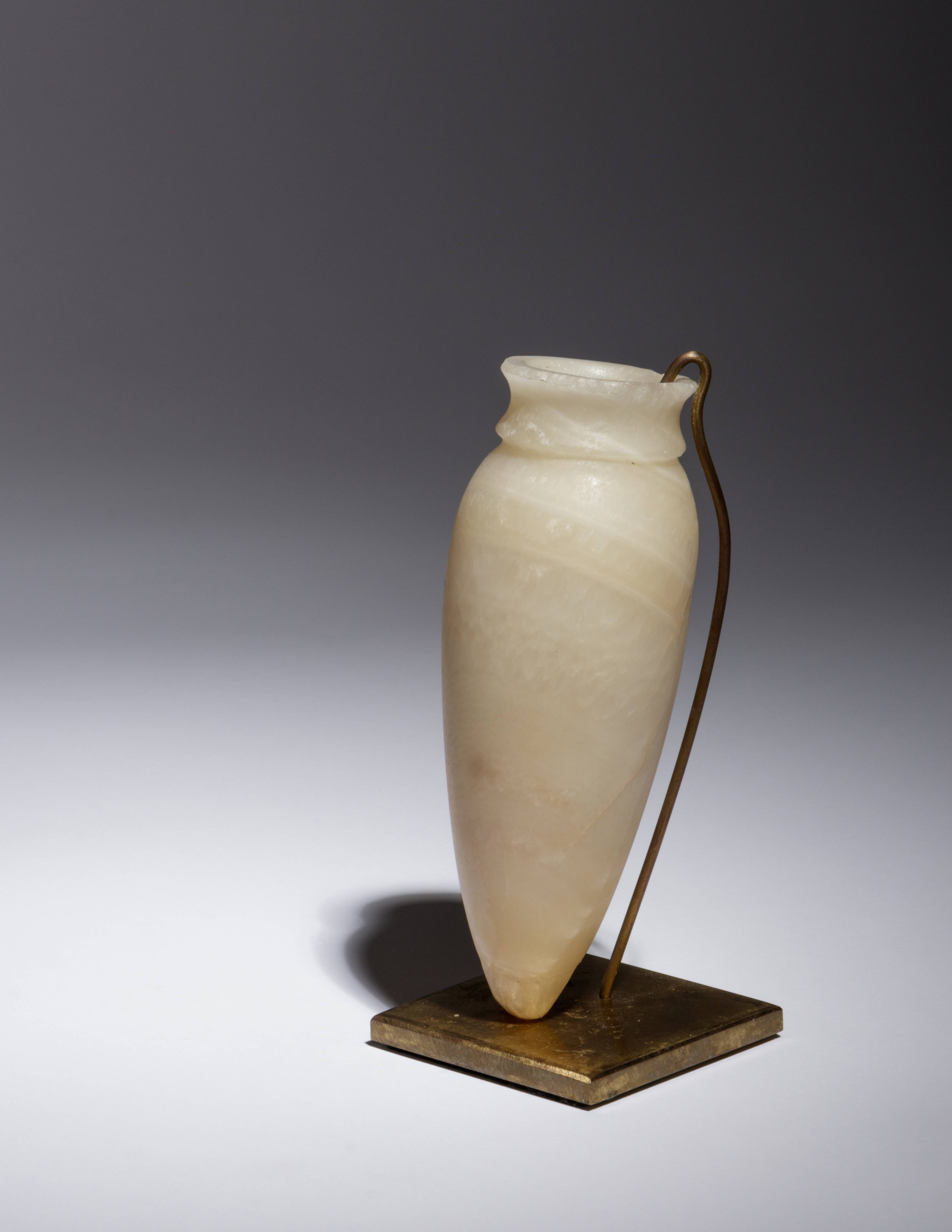 An Egyptian Alabaster Vessel Height 5 3/8 inches.