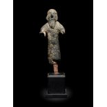 A Near Eastern Bronze Figure of a Man Height 3 inches.