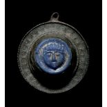 A Romano-Celtic Bronze and Blue Glass Fibula with a