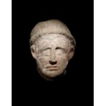 An Etruscan Over-Lifesized Nenfro Portrait Head of a