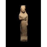 A Greek Terracotta Kore Height 9 1/2 inches.