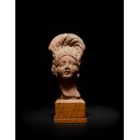 A Romano-Egyptian Terra Cotta Bust Height 3 1/2 inches.