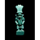 An Egyptian Faience Amulet of Bes Height 2 7/8 inches.