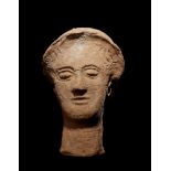 A Greek Terracotta Head Height 10 inches.