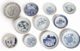 A GROUP OF ELEVEN BLUE AND WHITE PORCELAIN SAUCERS AND DISHES