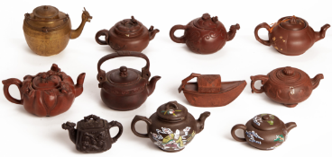 A COLLECTION OF ELEVEN YIXING POTTERY AND OTHER TEAPOTS
