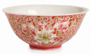 A SMALL RUBY GROUND FAMILLE ROSE BOWL