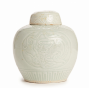 A SMALL PALE CELADON GLAZED DRAGON JAR AND COVER