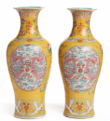 A PAIR OF YELLOW GROUND FAMILLE ROSE VASES