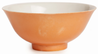 AN ORANGE GLAZED PORCELAIN BOWL