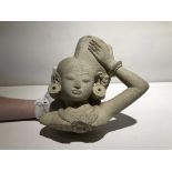 AN INDONESIAN CARVED STONE FIGURAL SECTION