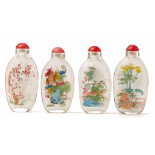 A SET OF FOUR GLASS SNUFF BOTTLES WITH FLORAL DESIGNS