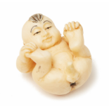 AN IVORY CARVING OF A BABY