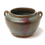 A JUN GLAZED TWIN HANDLED POTTERY JAR