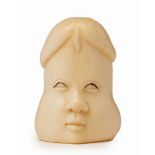 AN IVORY EROTIC FIGURINE OF A VISAGE AND PHALLUS