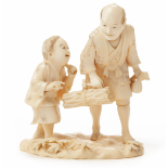 A JAPANESE IVORY OKIMONO OF A FATHER AND SON