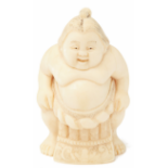 AN IVORY FIGURINE OF A SUMO WRESTLER
