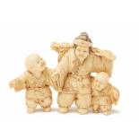AN IVORY FIGURAL NETSUKE GROUP OF A WOMAN AND TWO BOYS