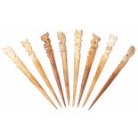 A GROUP OF CARVED BONE HAIR-PINS
