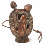 A WOODEN FIGURINE OF A FROG ON A LOTUS PLANT