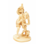 AN IVORY FIGURAL NETSUKE OF AN OLD MAN AND HIS DOG