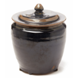 A BLACK-GLAZED JAR AND COVER