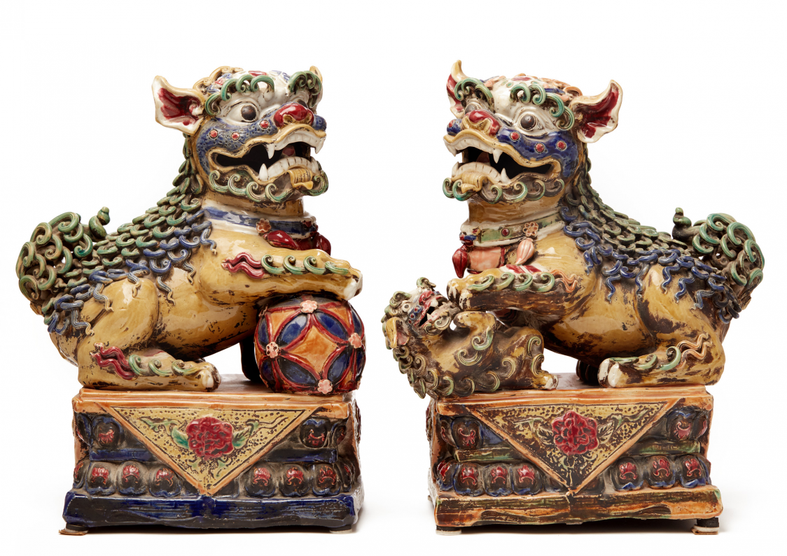 A PAIR OF VIVIDLY GLAZED POTTERY FOO DOGS (1)