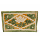 A CIZHOU SANCAI-GLAZED PILLOW WITH LOTUS