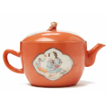 A CORAL GROUND FAMILLE ROSE TEAPOT AND COVER