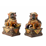 A PAIR OF VIVIDLY GLAZED POTTERY FOO DOGS (2)