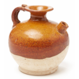 A SMALL BROWN-GLAZED GLOBULAR POTTERY EWER