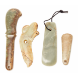 A GROUP OF FOUR JADE TOOLS AND AXE HEADS