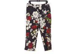 A PAIR OF BLACK DOLCE & GABBANA ROSE PATTERNED TROUSERS