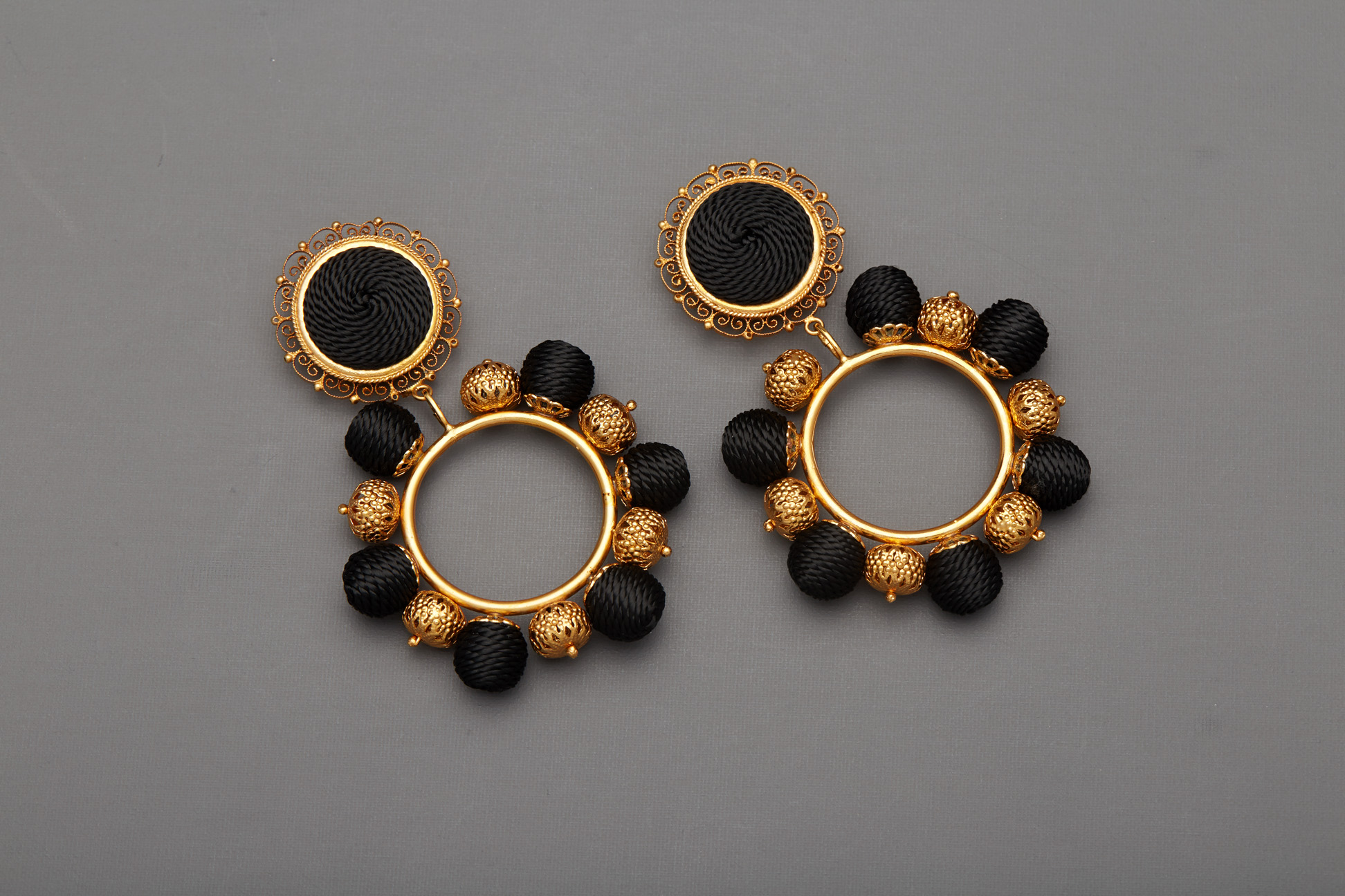 A PAIR OF DOLCE & GABBANA BLACK AND GOLD CLIP ON EARRINGS