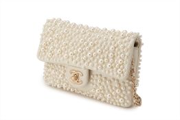 A CHANEL CREAM LEATHER W.O.C WITH PEARL EMBELLISHMENT PURSE